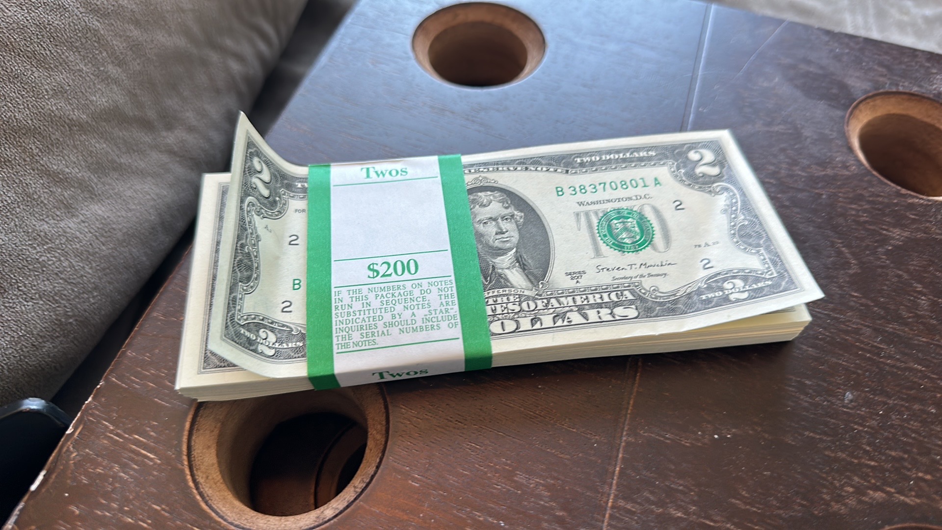 Stack of $2 bills - $200 in crisp two dollar bills from the bank